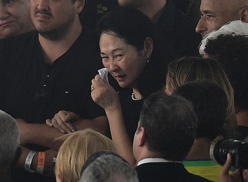 The wife of late Brazilian legend Pele, Marcia Aoki, during his wake at the Urbano Caldeira Stadium. AFP