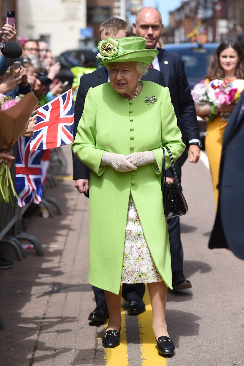 Queen Elizabeth II, wearing lime green, meets members of the public in Chester, England, on June 14, 2018. Getty Images