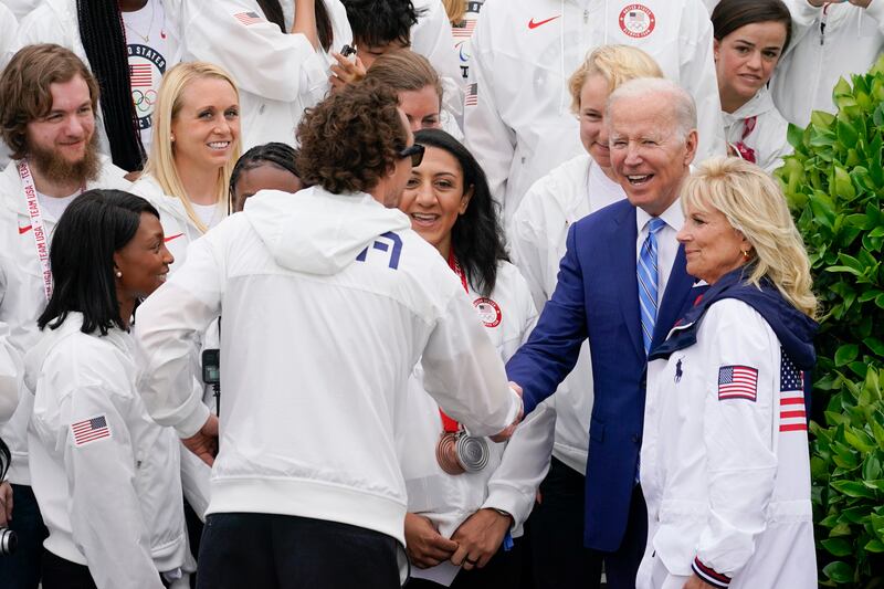 President Joe Biden and first lady Jill Biden with members of Team USA. AP