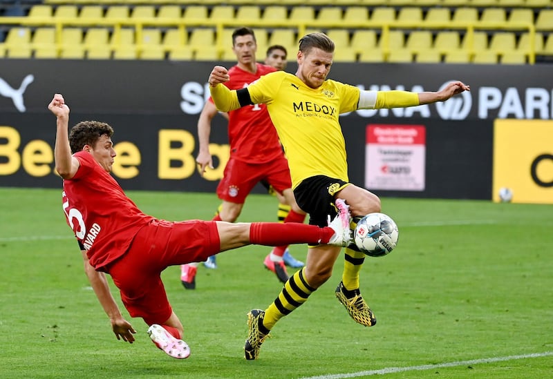 Bayern Munich's Benjamin Pavard in action with Borussia Dortmund's Lukasz Piszczek. Reuters