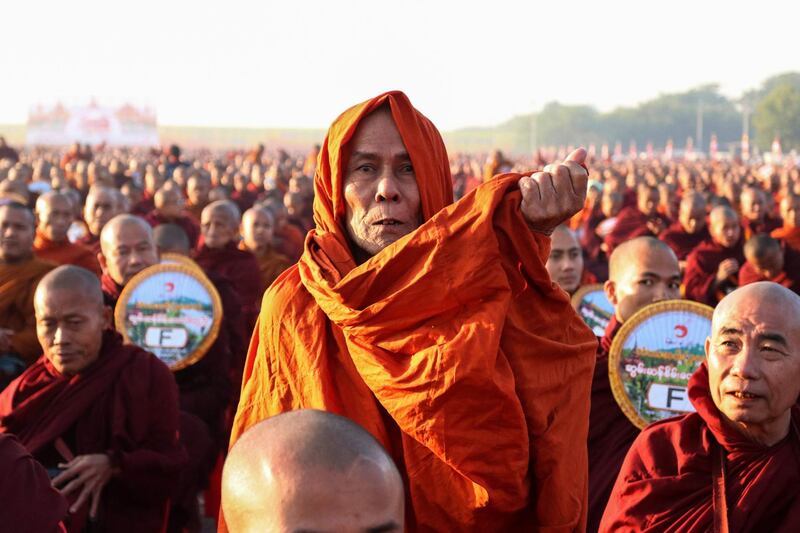 Monks line up for alms during the alms-giving ceremony to 30,000 monks organise by the region government of Mandalay.  AFP