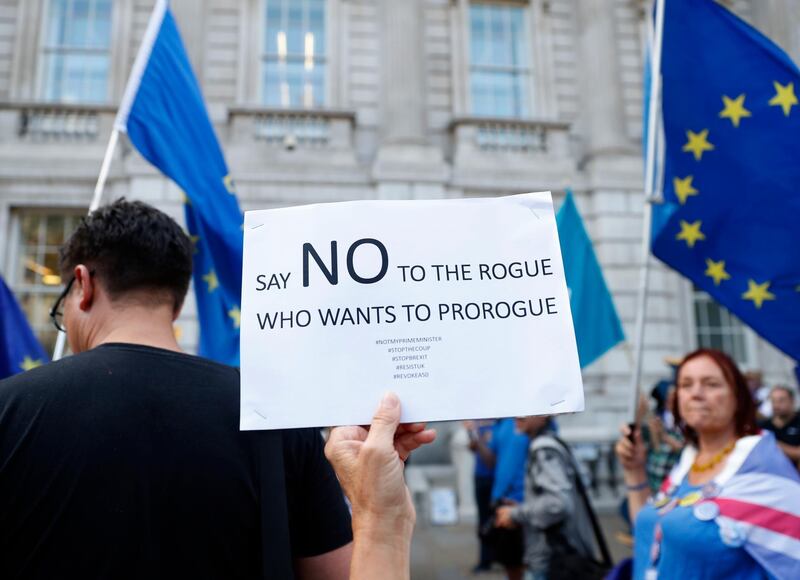 Anti Brexit demonstrators protest outside the Cabinet Office in central London, Thursday, Aug. 29, 2019. Political opposition to Prime Minister Boris Johnson's move to suspend Parliament is crystalizing, with protests around Britain and a petition to block the move gaining more than 1 million signatures. (AP Photo/Alastair Grant)