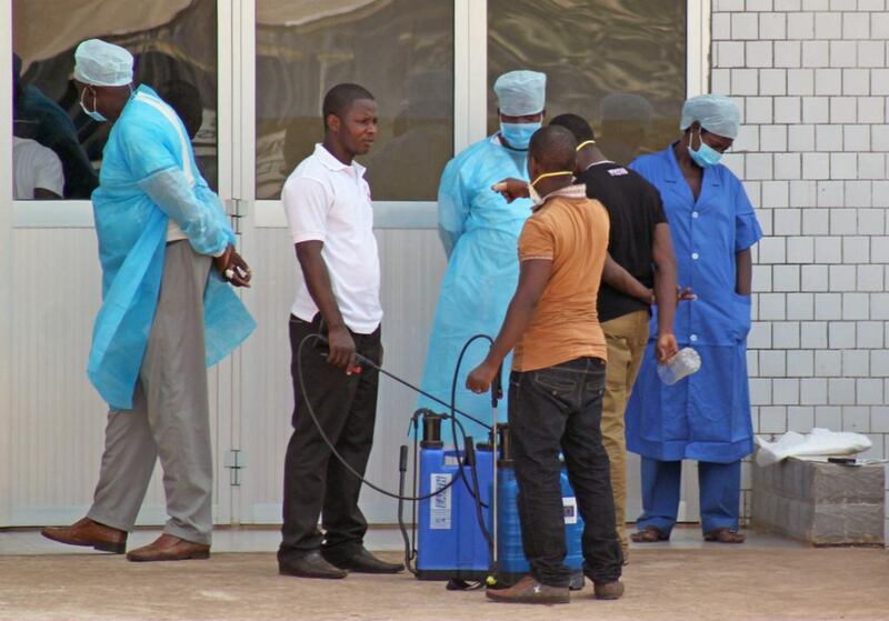 Medical personnel at the emergency entrance of a hospital wait to receive suspected Ebola virus patients in Conakry, Guinea on March 29. Youssouf Bah / AP