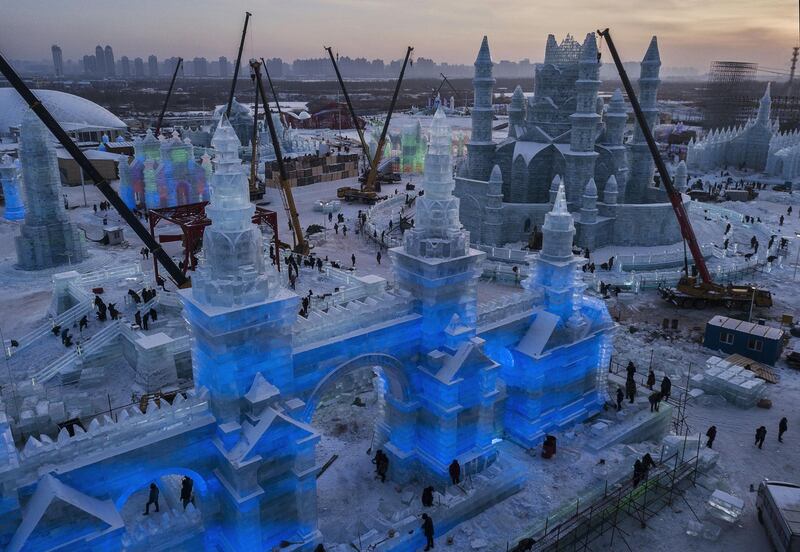 Chinese labourers work to finish large ice sculptures in preparation for the Harbin Ice and Snow Festival in Harbin, China. Getty Images