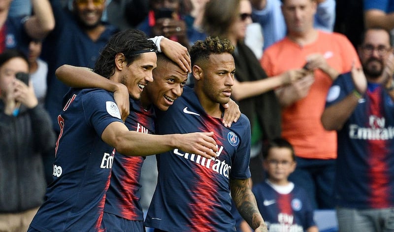 Paris Saint-Germain's Kylian Mbappe, centre, is congratulated by Neymar, right, and Edinson Cavani after scoring a goal. AFP