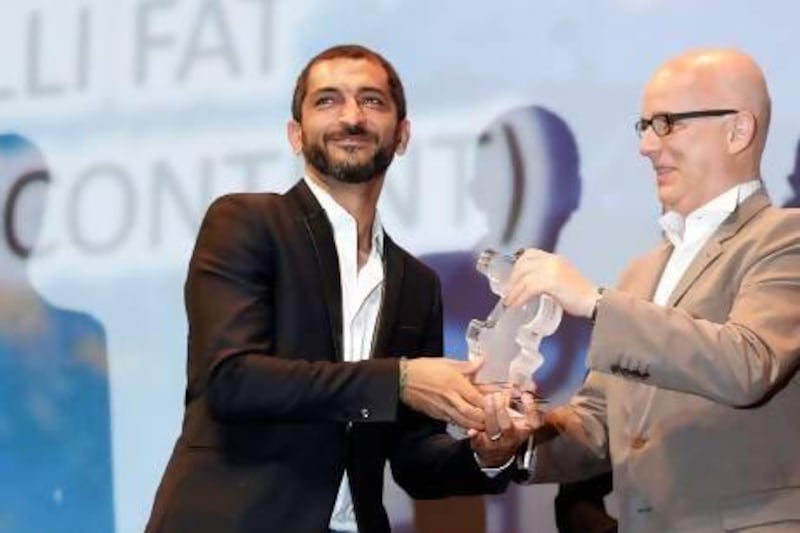 The Eygptian actor Amr Waked, left, accepts an award at the Dubai International Film Festival in December. Karim Sahib / AFP