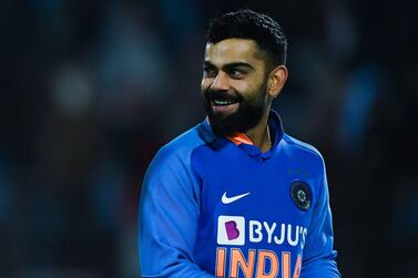 India's captain Virat Kohli smiles after defeating Australia during the second one day international in Rajkot. AFP