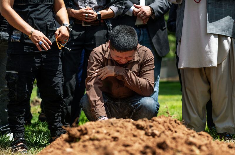 Altaf Hussein cries over the grave of his brother Aftab Hussein at Fairview Memorial Park in Albuquerque, New Mexico. The Albuquerque Journal / AP