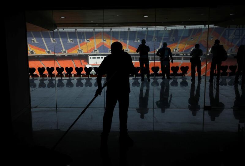 A worker cleans an entrance area inside Sardar Patel Stadium in Ahmedabad. Reuters