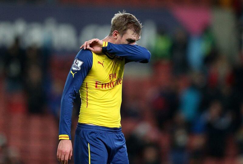 Per Mertesacker of Arsenal reacts at the end of his side's 3-2 loss to Stoke City on Saturday. Clive Mason / Getty Images