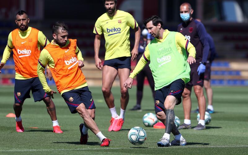 Lionel Messi and Jordi Alba compete for the ball during a training session at Ciutat Esportiva Joan Gamper. Getty Images