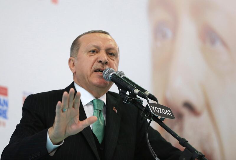 Turkey's President Recep Tayyip Erdogan talks to supporters of his ruling Justice and Development Party (AKP), at a rally in Yozgat, eastern Turkey, Sunday, Jan. 14, 2018.  Erdogan said Sunday the country will launch a military assault on a Kurdish enclave in northern Syria "in the coming days," and urged the U.S. to support its efforts. (Pool Photo via AP)