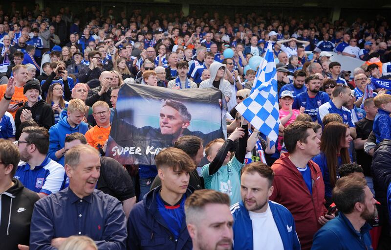 Ipswich Town fans with a banner featuring manager Keiran McKenna. PA 