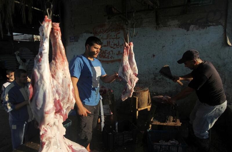 Butchers in Gaza city prepare the meat of animals slaughtered on the first day of Eid Al Adha.