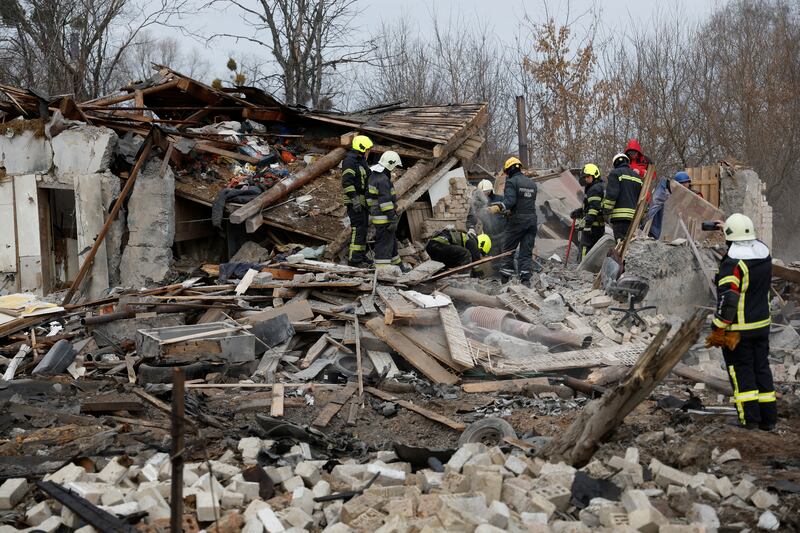 Rescuers in Kyiv search the rubble of a house hit in a Russian missile strike. Reuters