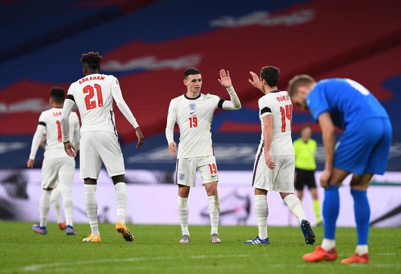 England's Phil Foden, centre, celebrates after scoring his team's fourth goal. AP
