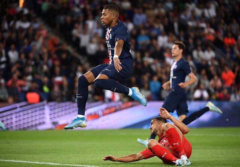 Paris Saint-Germain's French forward Kylian Mbappe (top) avoids Nimes' French defender Pablo Martinez. AFP