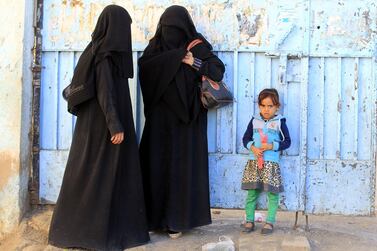 Displaced Yemeni women wait to register at an evacuation centre. EPA 