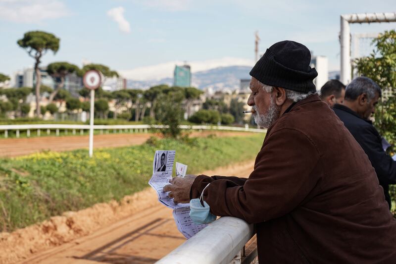 A man inspects race day statistics.