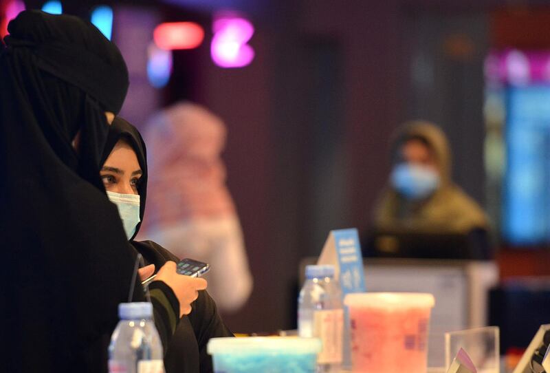 Saudi women buy tickets for a movie at a cinema in the capital Riyadh as cinemas re-opened.  AFP
