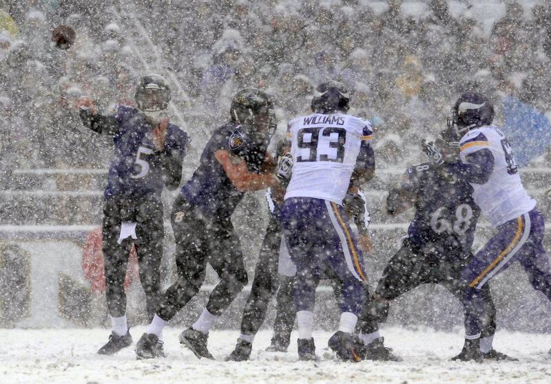 Not far from Washington, in Baltimore, Maryland, the Baltimore Ravens and Minnesota Vikings played in the snow. Above, Baltimore quarterback Joe Flacco, far left, attempts a pass. Gail Burton / AP