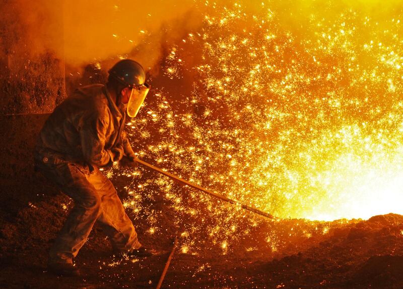 An employee works next to molten iron at a steel mill of Dongbei Special Steel in Dalian, Liaoning province, China. Reuters