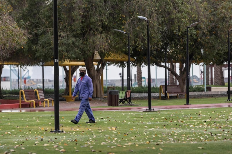 DUBAI, UNITED ARAB EMIRATES. 16 APRIL 2020. General STANALONE image for COVID coverage. A municipal worker walks in a closed park in Jumeirah with his face covered. (Photo: Antonie Robertson/The National) Journalist: STANDALONE. Section: National.