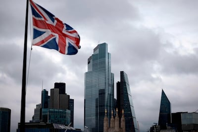 A Union Flag flutters in the wind near office builings in the City of London in London on November 25, 2020. Britain's economy is set to shrink 11.3 percent this year, suffering the greatest annual slump in more than three centuries on coronavirus fallout, the government forecast Wednesday. The economy is expected to rebound 5.5 percent next year and 6.6 percent in 2022, finance minister Rishi Sunak told parliament.
 / AFP / Tolga Akmen
