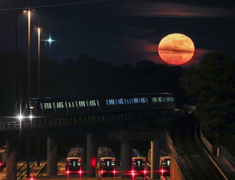 The supermoon rises behind a MARTA commuter train in Avondale Estates, Georgia, US. Erik Lesser / EPA