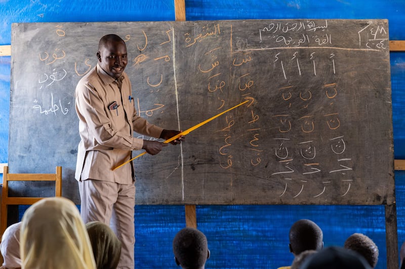Thirty-six-year-old Sudanese refugee and teacher Abdulrachid Adam Mohammed gives Arabic lessons at the Al Tadamoun school in the Farchana refugee camp