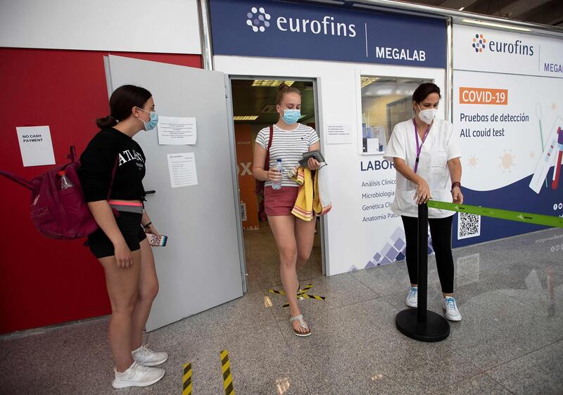 A tourist leaves a Covid-19 testing station at Son Sant Joan airport in Palma de Mallorca. AFP