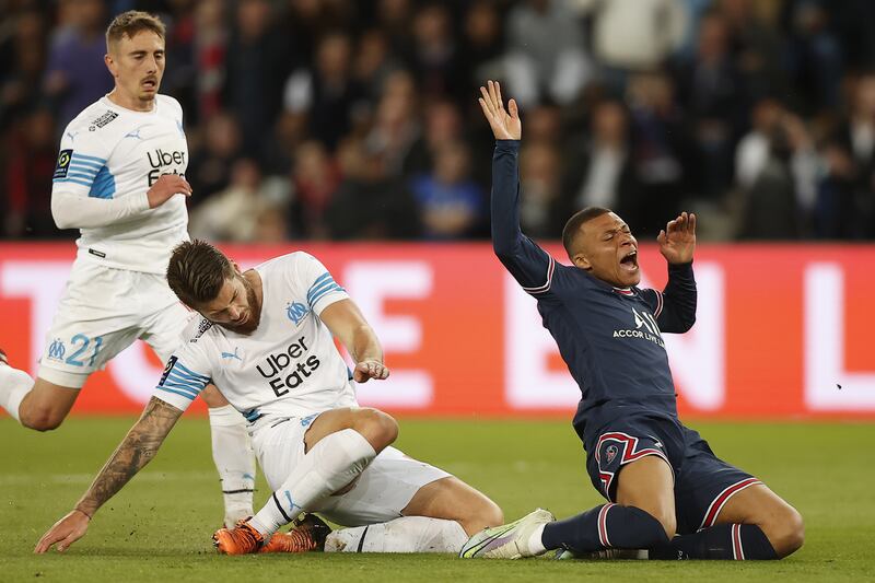 Paris Saint-Germain's Kylian Mbappe, right, if fouled by Marseille's Duje Caleta-Car. EPA 