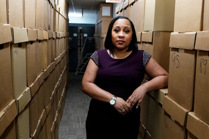 Fulton County District Attorney Fani Willis poses among boxes containing thousands of primal cases at her office in Atlanta, Georgia. AP