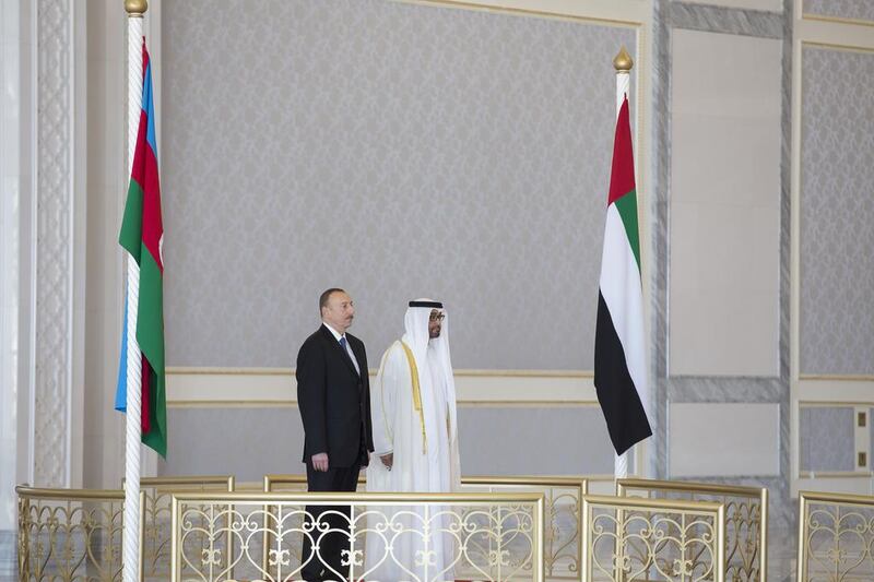 Sheikh Mohamed bin Zayed, Crown Prince of Abu Dhabi and Deputy Supreme Commander of the Armed Forces, and Ilham Aliyev, President of Azerbaijan, stand for the UAE National Anthem during a reception held at the Presidential Airport.  Mohamed Al Hammadi / Crown Prince Court - Abu Dhabi