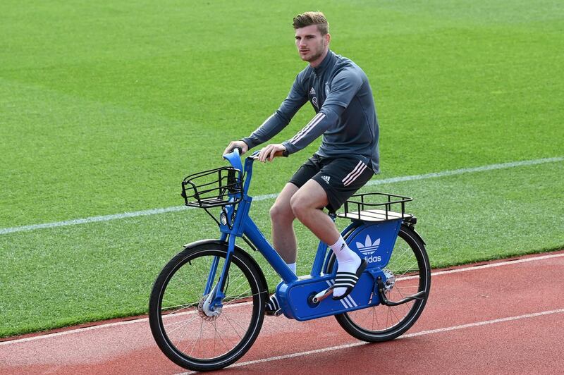 Germany forward Timo Werner arrives on a bicycle. AFP