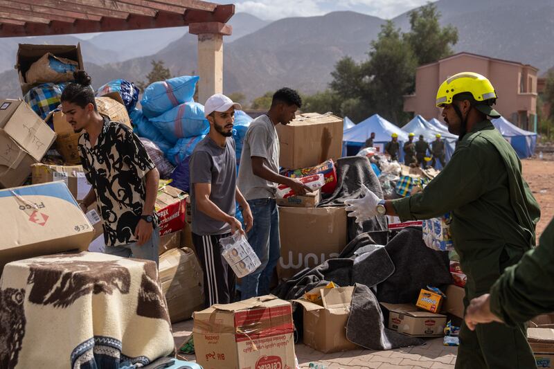 Aid workers distribute relief supplies in Talat N'Yaaqoub. Getty Images