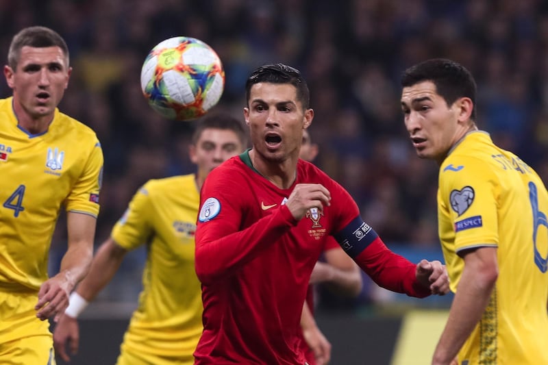 Ukraine`s Taras Stepanenko in action against Portugal`s Cristiano Ronaldo. EPA