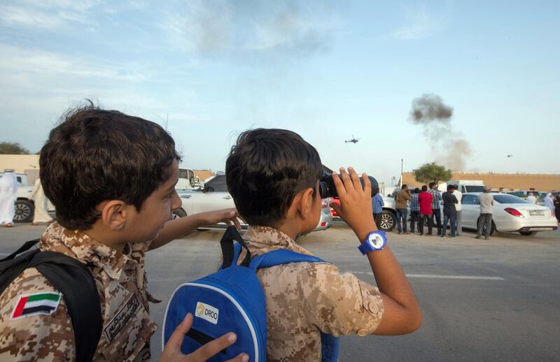 FUJAIRAH, UNITED ARAB EMIRATES - Kids with their military costume watching from the street of  the Fourth Union Fortress, Fujairah.  Leslie Pableo for The National for Ruba Haza’s story