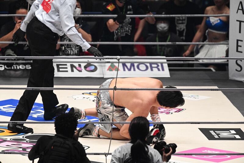 Mikuru Asakura  tries to get up after being knocked down by  Floyd Mayweather. AFP