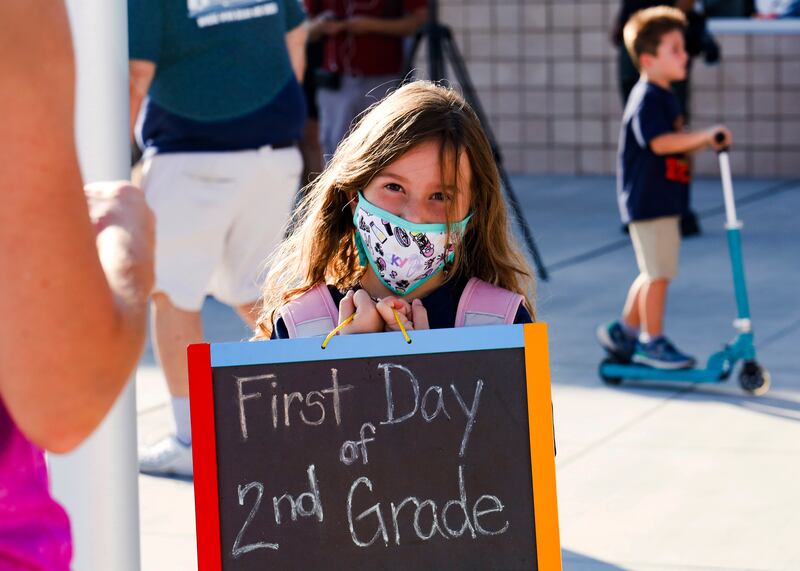 Charlie Gonzalez holds up a sign during the first day of school at the new Hannah Marie Brown Elementary School in Henderson, Nevada, US, on August  9, 2021. AP