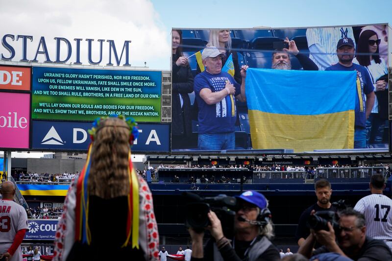 Yulia Holiyat, 11, of Brooklyn, sings the Ukrainian national anthem in honour of the country's struggle in their war with Russia before the New York Yankees opening day baseball game against the Boston Red Sox. AP