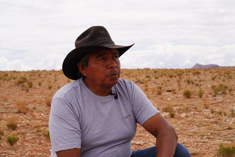 Franklin Martin, a Navajo rancher, looks out at the dry earth dam in the Bodaway area of the Navajo Nation reservation.