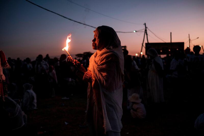Ethiopian orthodox christians holds a candle during the celebration of Timkat, the Ethiopian Epiphany, in Jan Meda sports ground in Addis Ababa. AFP Photo