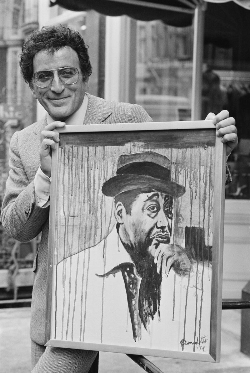 Tony Bennett holding one of his paintings, which he created under the name Anthony Benedetto, in November 1977. Getty Images