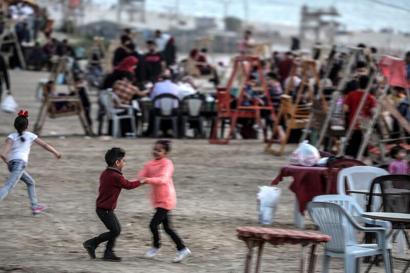 Children play as Palestinian families eat Iftar on the beach during the holy month of Ramadan in Gaza City, Gaza Strip, 16 May 2019. EPA