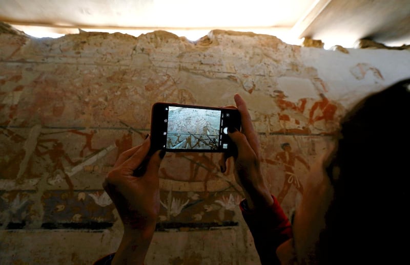 A reporter takes a mobile photo for discovery tomb of a priestess named "Hetpet" belonging to a fifth dynasty in Old Kingdom at the Giza plateau, the site of the three ancient pyramids on the outskirts of Cairo, Egypt February 3, 2018. REUTERS/Amr Abdallah Dalsh