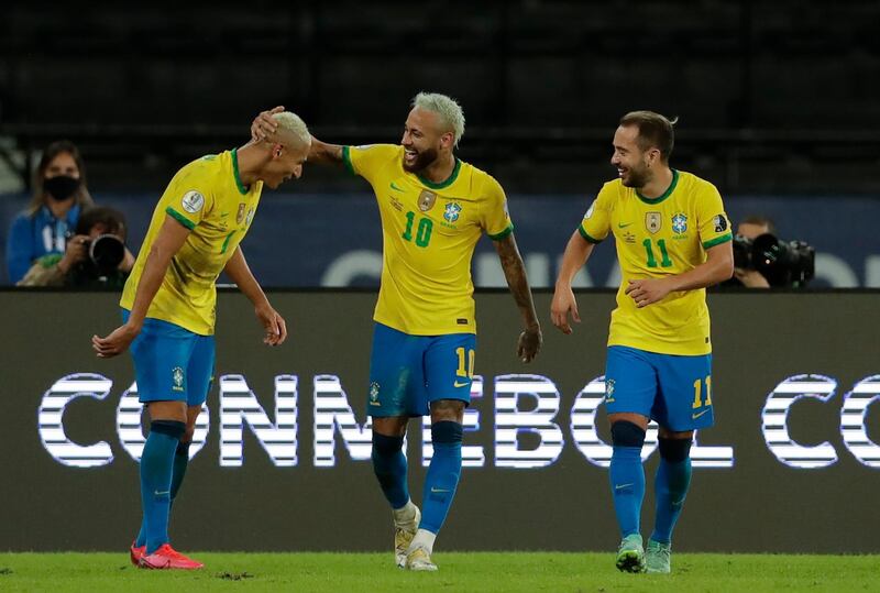Brazil's Richarlison, left, celebrates with teammates Neymar, centre, and Everton Ribeiro after scoring his side's fourth goal. AP