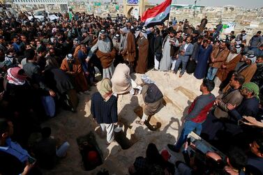 Iraqi men bury the victims of a suspected ISIS attack in the cemetery in Najaf. Reuters