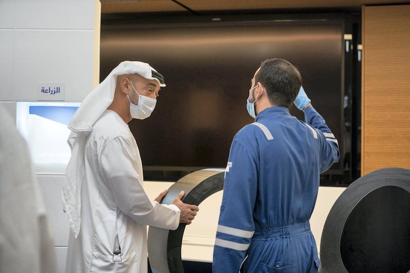 The Crown Prince of Abu Dhabi speaks to an engineer while visiting an Adnoc facility in Ruwais. Courtesy: Sheikh Mohamed bin Zayed Twitter
