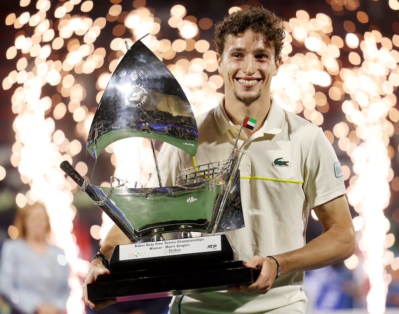 Ugo Humbert of France celebrates with the trophy after beating Alexander Bublik of Kazakhstan 6-4, 6-3 in the final of the Dubai Duty Free Tennis Championships at Dubai Duty Free Tennis Stadium on March 2, 2024. Getty Images